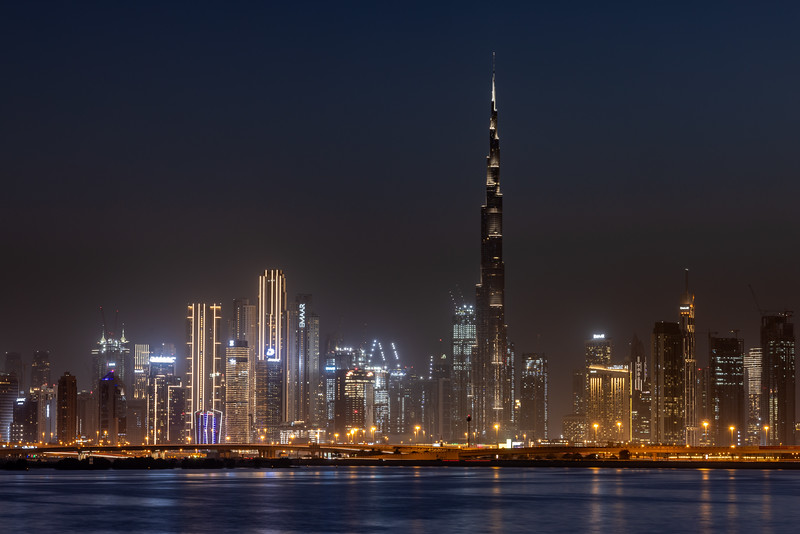 Dubai skyline at night with waterfall in neon colors